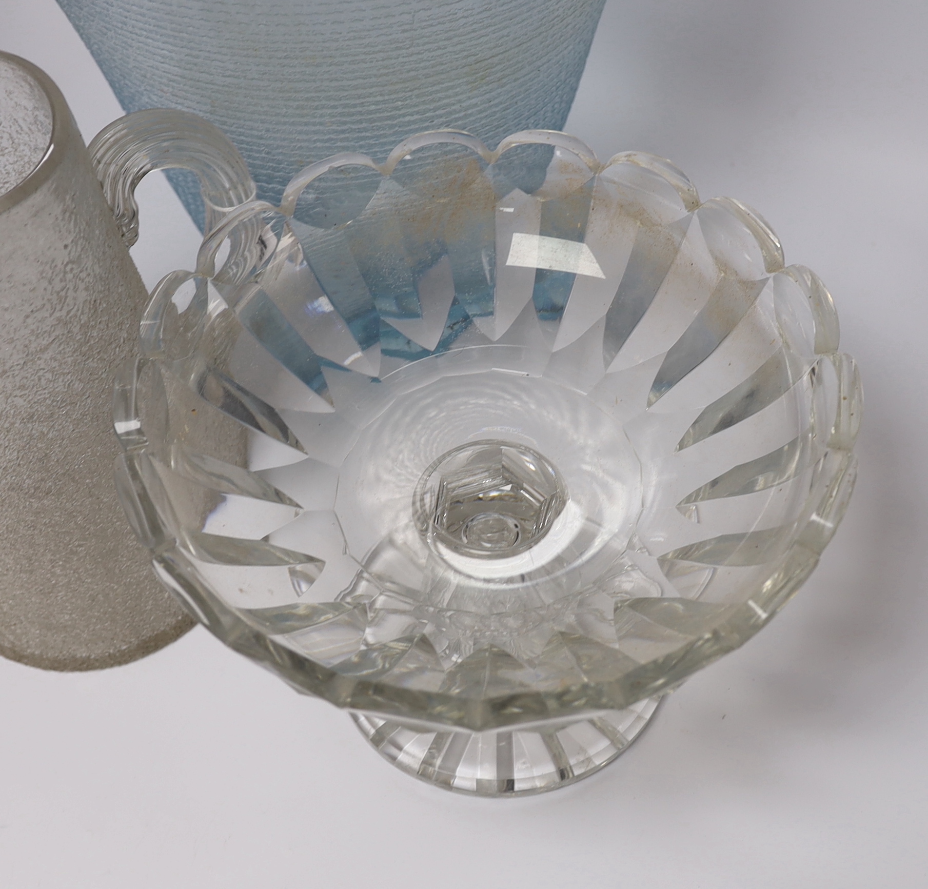 A large heavy cut glass tazza with shaped rim, a tall blue tinted textured vase, height 31.5cm and a crackle finish water jug (3)